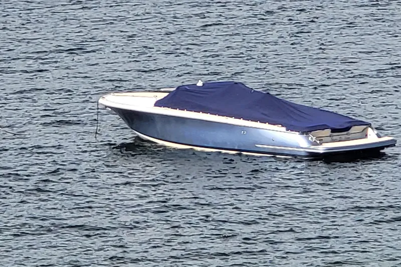 Slide: The Image of 2014 Chris Craft Corsair 34 boat with blue cover on water. - 6