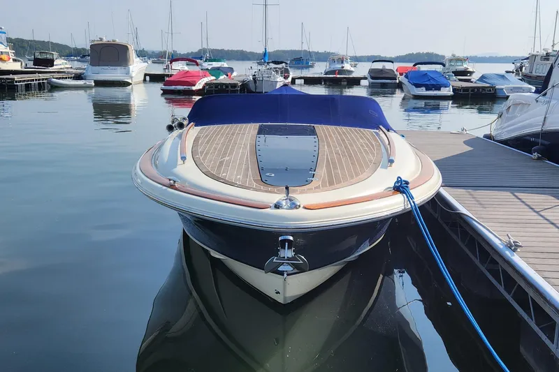 Slide: The Image of 2014 Chris Craft Corsair 34 docked at a marina with other boats. - 7