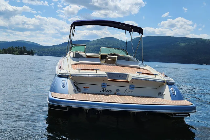 Slide: The Image of 2014 Chris Craft Corsair 34 boat on a scenic lake with mountains in the background. - 9