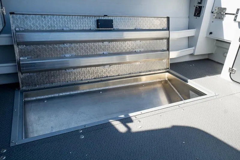 Slide: The Image of Open storage compartment on 2026 KingFisher 2325 Coastal Express boat deck. - 13