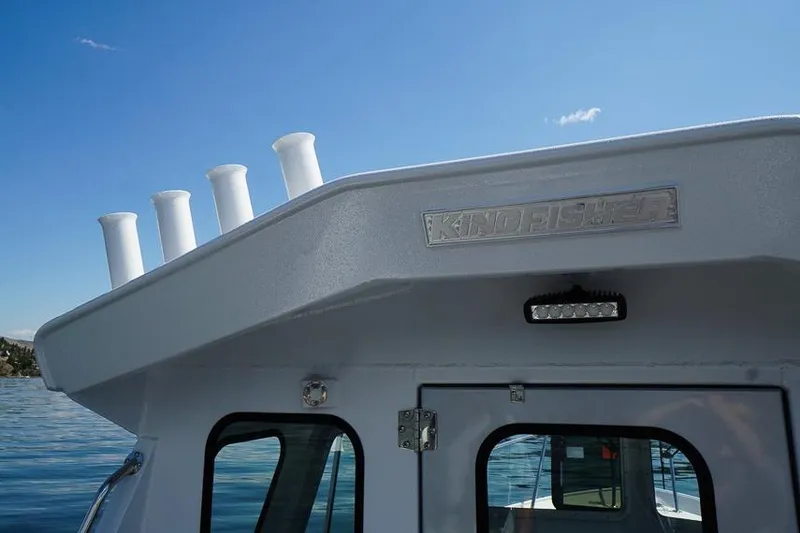 Slide: The Image of 2026 KingFisher 2325 Coastal Express boat on water under clear blue sky. - 14