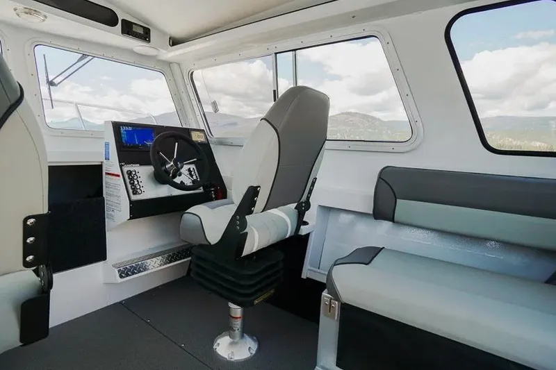 Slide: The Image of Interior of 2026 KingFisher 2325 Coastal Express boat, featuring helm and seating. - 5