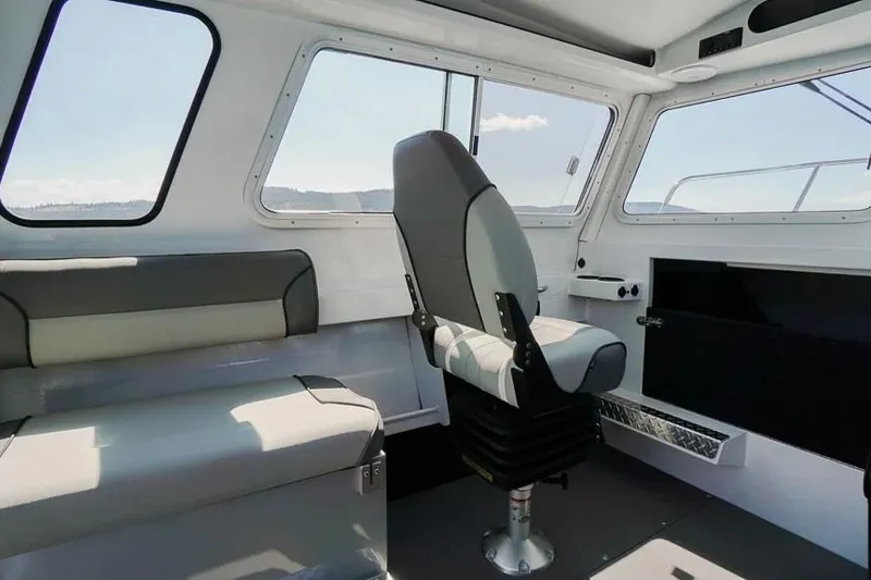 Slide: The Image of Interior of 2026 KingFisher 2325 Coastal Express boat, featuring seating and windows. - 6