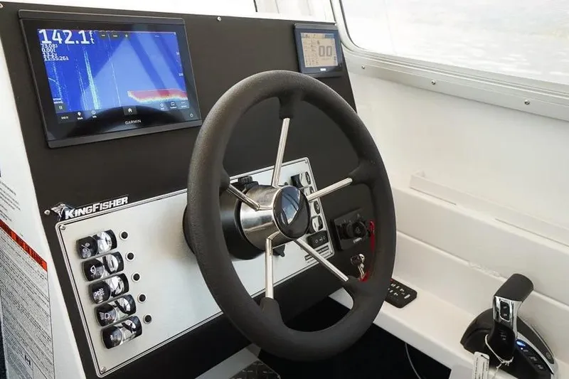 Slide: The Image of Steering console of 2026 KingFisher 2325 Coastal Express with modern navigation displays. - 7