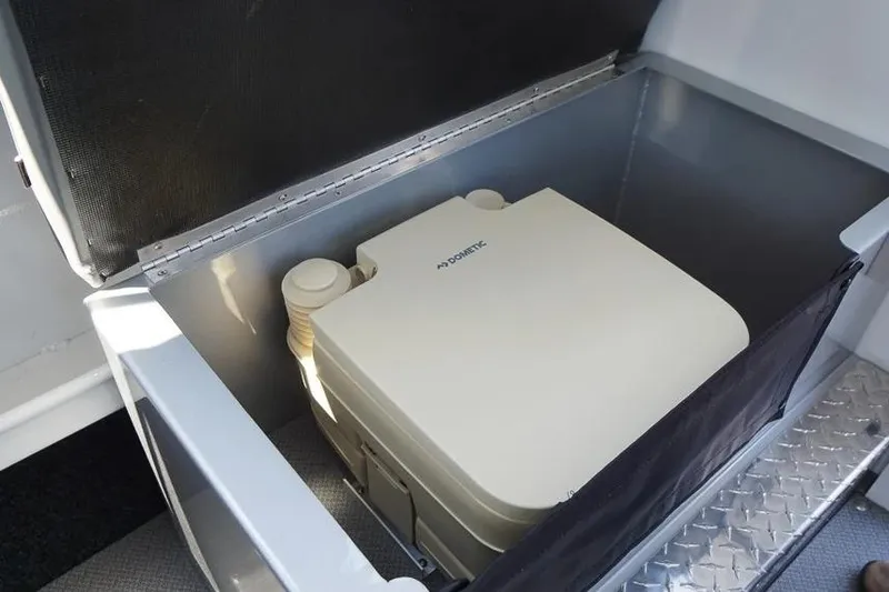 Slide: The Image of Portable toilet in storage compartment of 2026 KingFisher 2325 Coastal Express boat. - 8