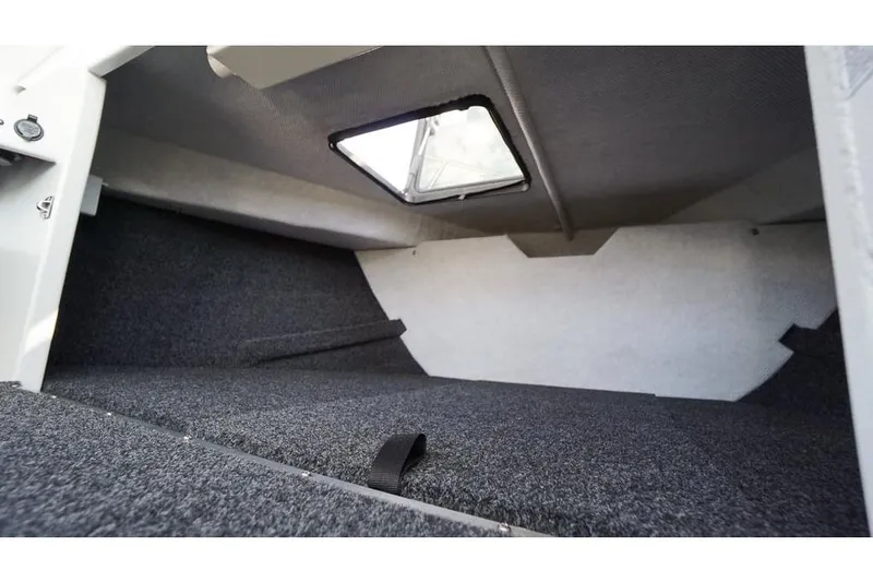 Slide: The Image of Interior cabin of 2026 KingFisher 2325 Coastal Express boat, featuring carpeted flooring. - 9