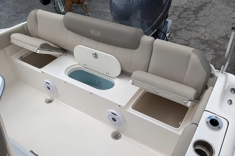 Slide: The Image of 2021 Key West 219 FS boat interior with cushioned seating and storage compartments. - 10