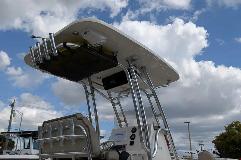 Slide: The Image of 2021 Key West 219 FS boat with T-top under a cloudy sky. - 23