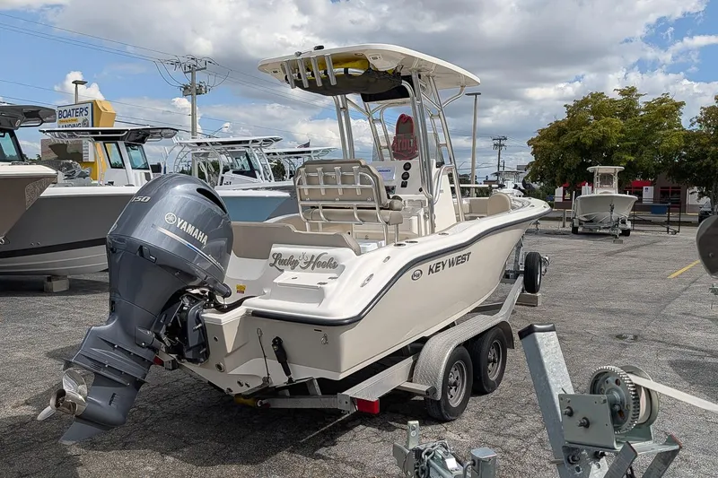 Slide: The Image of 2021 Key West 219 FS boat with Yamaha engine on trailer in parking lot. - 3
