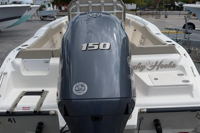 Slide: The Image of 2021 Key West 219 FS boat with a 150 horsepower engine, docked outdoors. - 5
