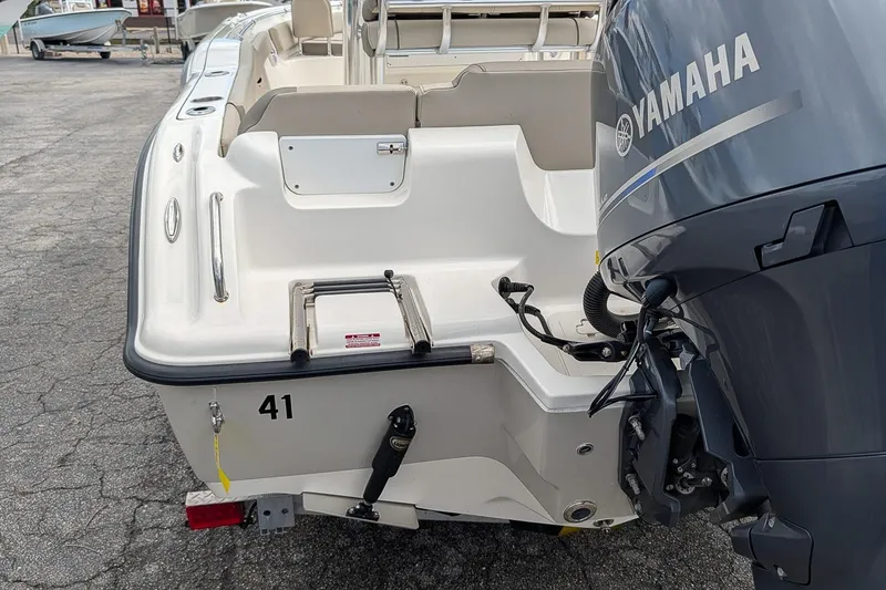 Slide: The Image of 2021 Key West 219 FS boat with Yamaha motor, rear view showing swim platform and ladder. - 6