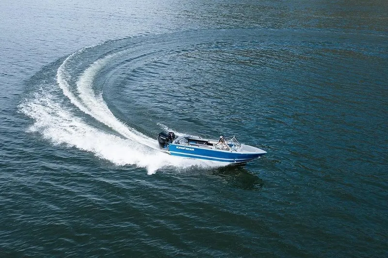 Slide: The Image of KingFisher 2025 Escape boat making a sharp turn on open water, 2026 model. - 3