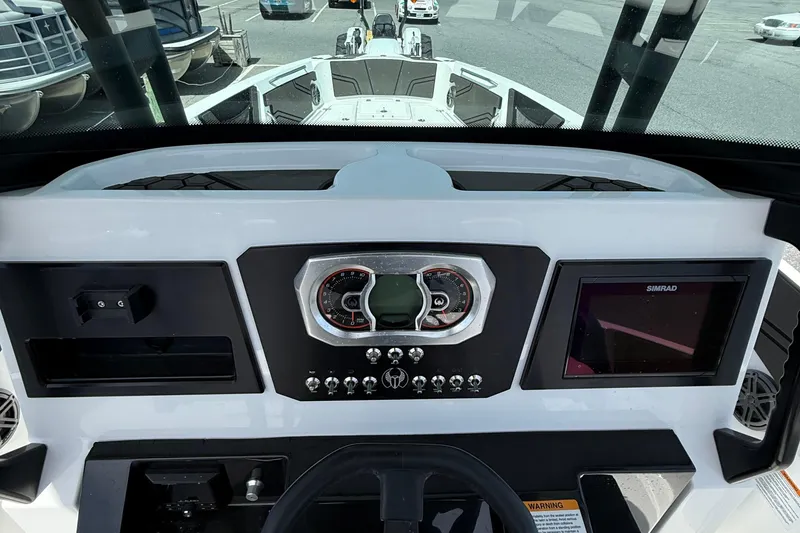 Slide: The Image of 2021 Scarab 255 Open ID boat dashboard with gauges and Simrad display. - 12