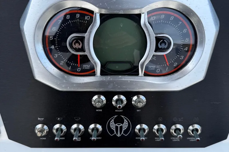 Slide: The Image of Dashboard of a 2021 Scarab 255 Open ID boat with gauges and switches. - 14