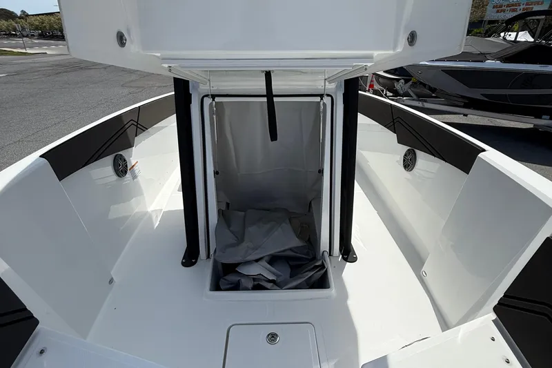 Slide: The Image of 2021 Scarab 255 Open ID boat interior with storage compartment open. - 16
