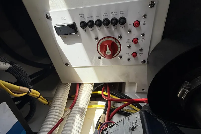 Slide: The Image of Control panel of a 2021 Scarab 255 Open ID boat with wiring and switches. - 18