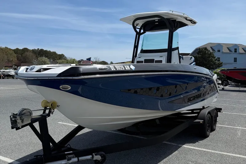 Slide: The Image of 2021 Scarab 255 Open ID boat on trailer in parking lot, sunny day. - 4