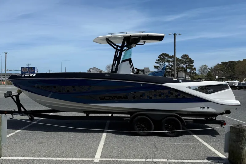 Slide: The Image of 2021 Scarab 255 Open ID boat on trailer in parking lot. - 5