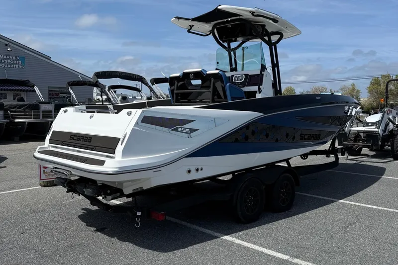 Slide: The Image of 2021 Scarab 255 Open ID boat on trailer in parking lot, side view. - 8