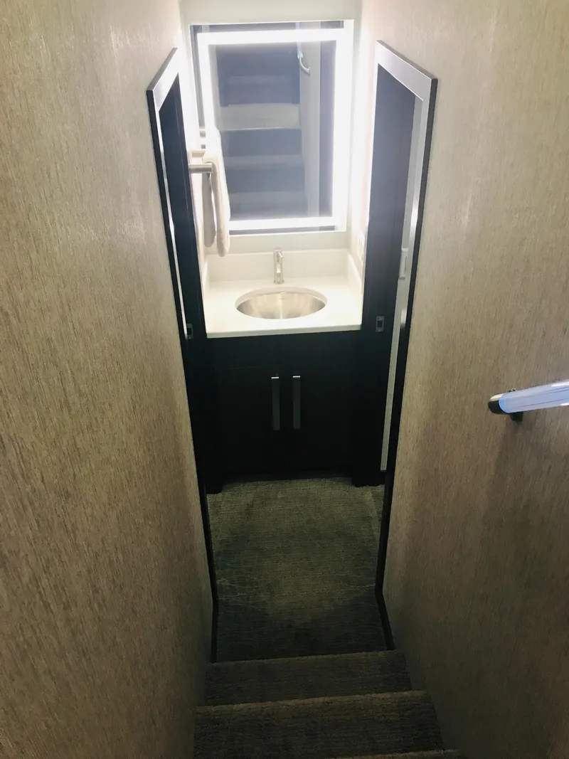 Slide: The Image of Narrow stairway leading to a compact bathroom with a sink, in a 2018 Adonia Adonis Trip 3. - 11