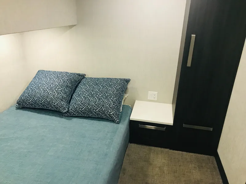 Slide: The Image of Compact bedroom in Adonia Adonis Trip 3, 2018 model, with blue bedding and modern decor. - 12