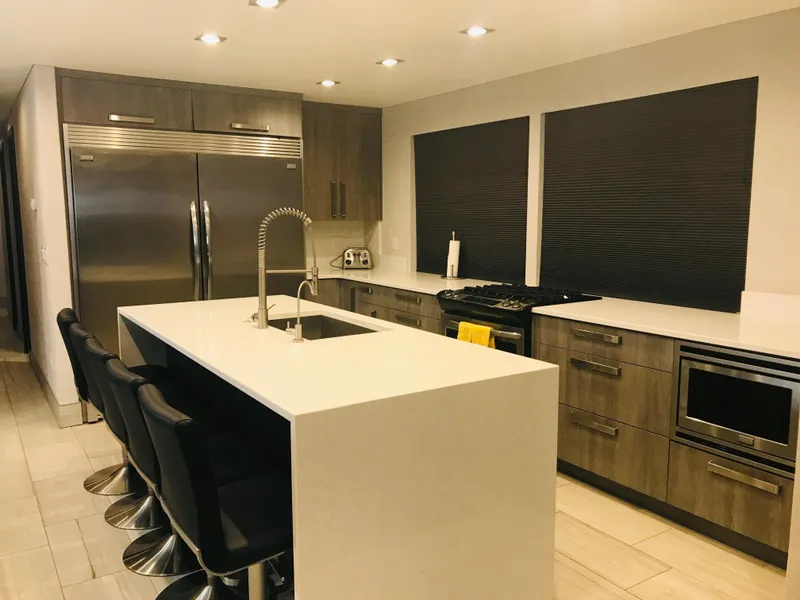 Slide: The Image of Modern kitchen with sleek island, stainless steel appliances, and dark cabinetry, Adonia Adonis Trip 3, 2018. - 22
