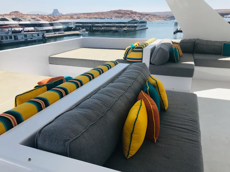 Slide: The Image of Luxurious Adonia Adonis Trip 3 yacht with colorful cushions, docked at a scenic marina. - 33