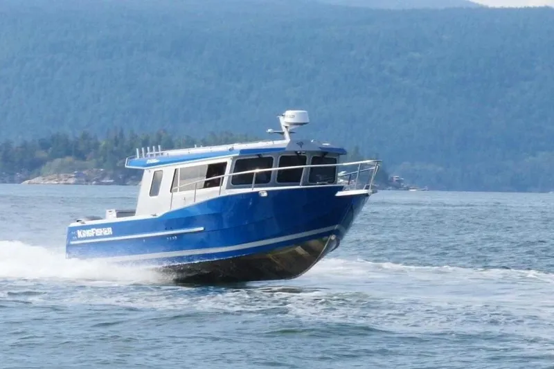The Image of 2026 KingFisher 3225 GFX Offshore boat cruising on a scenic lake. - 1