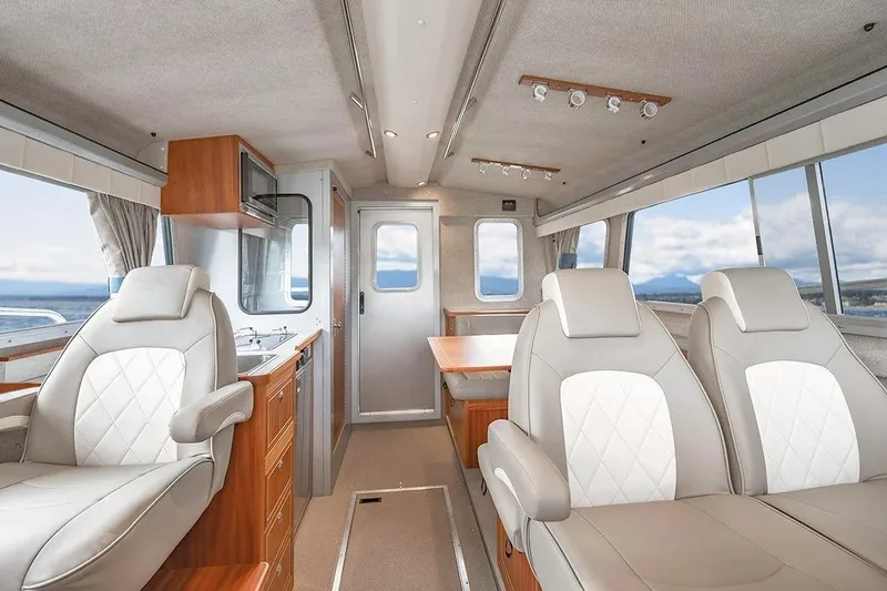 Slide: The Image of Luxurious interior of 2026 KingFisher 3225 GFX Offshore boat with leather seating and kitchenette. - 12