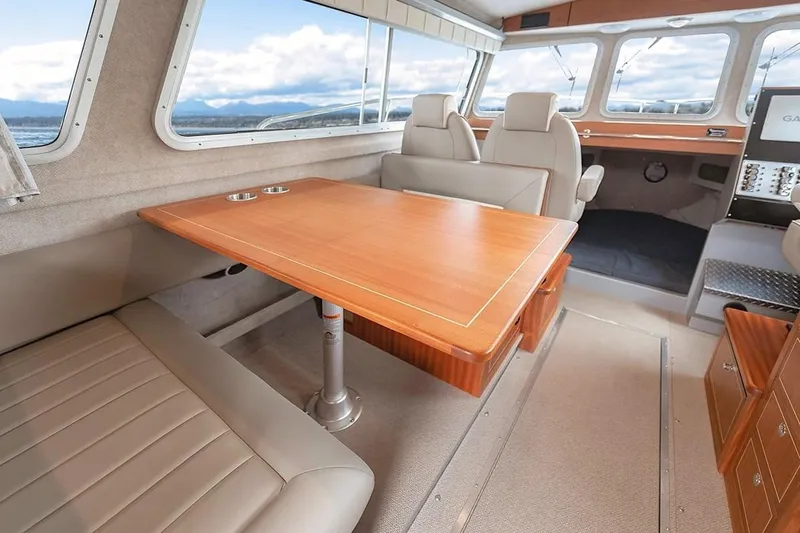 Slide: The Image of Interior of 2026 KingFisher 3225 GFX Offshore boat with seating and wooden table. - 13