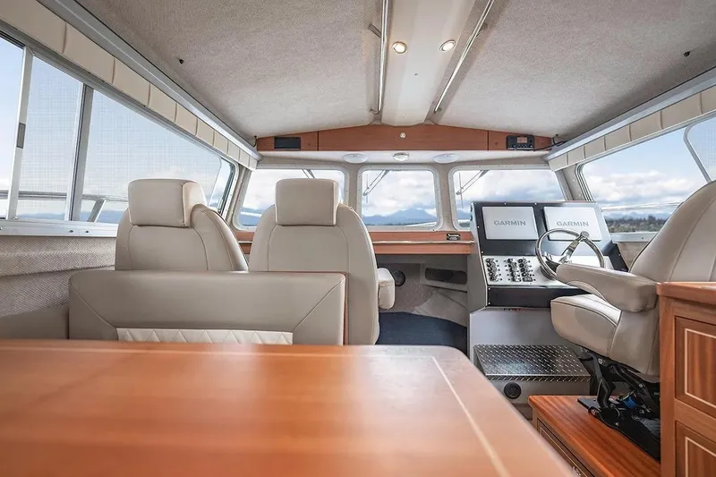 Slide: The Image of Interior of 2026 KingFisher 3225 GFX Offshore boat with modern seating and navigation equipment. - 15