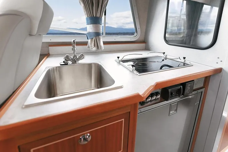 Slide: The Image of Modern kitchen area in 2026 KingFisher 3225 GFX Offshore boat with sink and stove. - 18