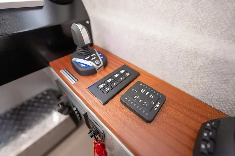 Slide: The Image of Control panel of 2026 KingFisher 3225 GFX Offshore boat with joystick and switches. - 20