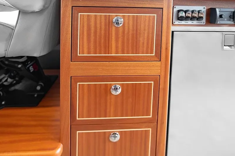 Slide: The Image of Wooden cabinet drawers in a 2026 KingFisher 3225 GFX Offshore boat interior. - 22