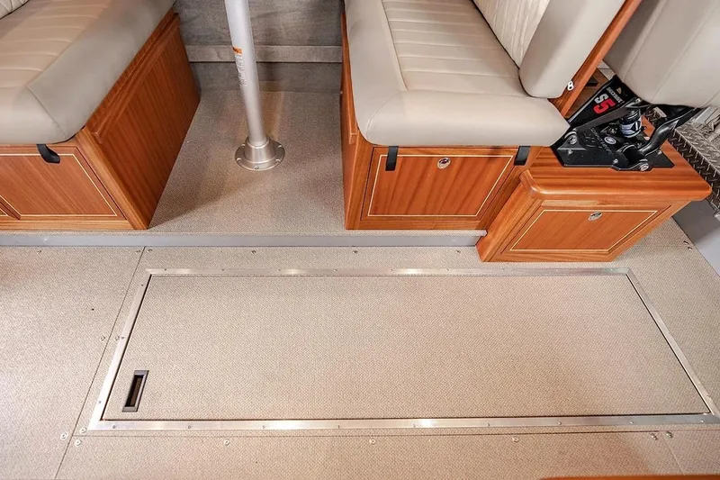 Slide: The Image of Interior of 2026 KingFisher 3225 GFX Offshore boat with cushioned seating and storage compartments. - 24