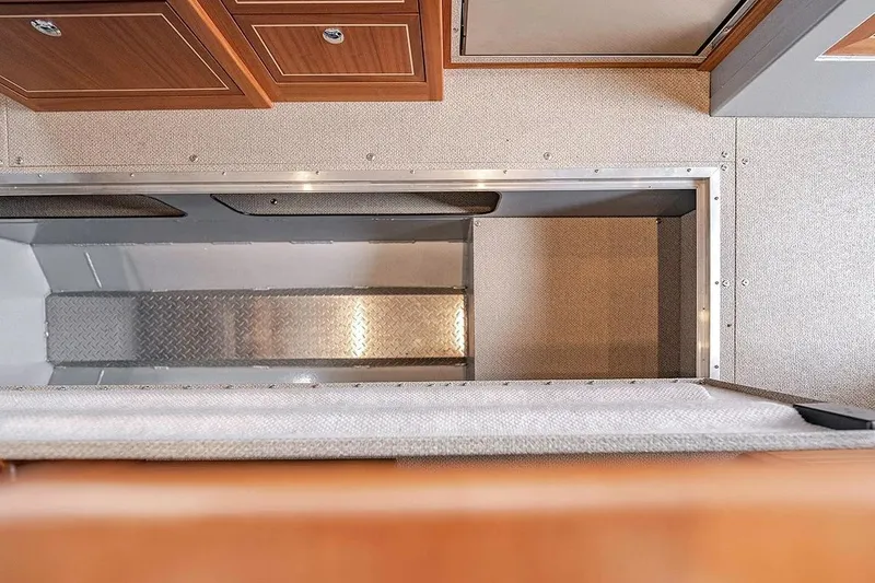 Slide: The Image of Interior view of 2026 KingFisher 3225 GFX Offshore boat, featuring storage compartment and cabinetry. - 27