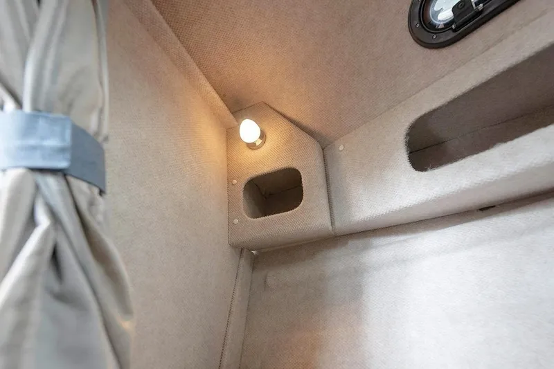 Slide: The Image of Interior cabin of 2026 KingFisher 3225 GFX Offshore boat, featuring cozy lighting and storage. - 30