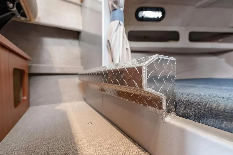 Slide: The Image of Interior of 2026 KingFisher 3225 GFX Offshore boat, featuring diamond plate detail. - 32