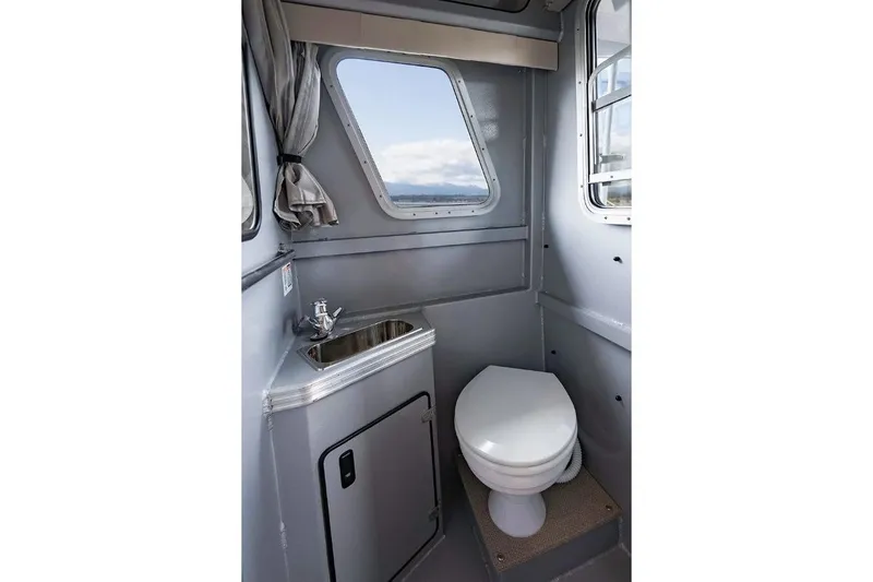 Slide: The Image of Interior of 2026 KingFisher 3225 GFX Offshore boat bathroom with sink and toilet. - 33