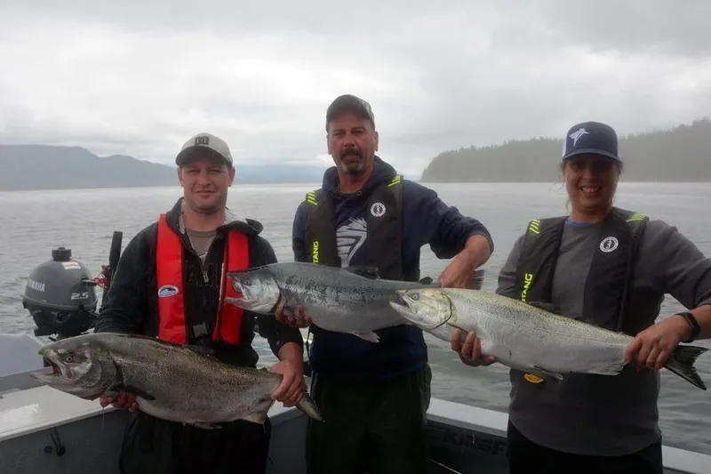 Slide: The Image of Three people holding large fish on a KingFisher 3225 GFX Offshore boat, 2026 model. - 39
