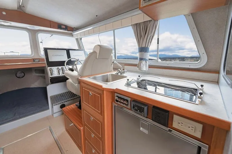 Slide: The Image of Interior of 2026 KingFisher 3225 GFX Offshore boat with modern kitchen and helm. - 6