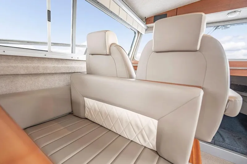 Slide: The Image of Luxurious interior seating of 2026 KingFisher 3225 GFX Offshore boat, featuring elegant beige upholstery. - 8