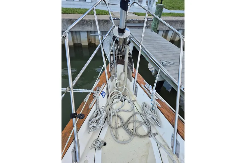 Slide: The Image of 1987 Morgan 384 sailboat deck with ropes and railing at dock. - 11