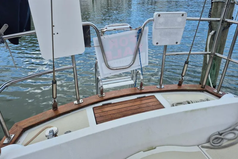 Slide: The Image of 1987 Morgan 384 sailboat stern with wooden deck and stainless steel railings. - 13