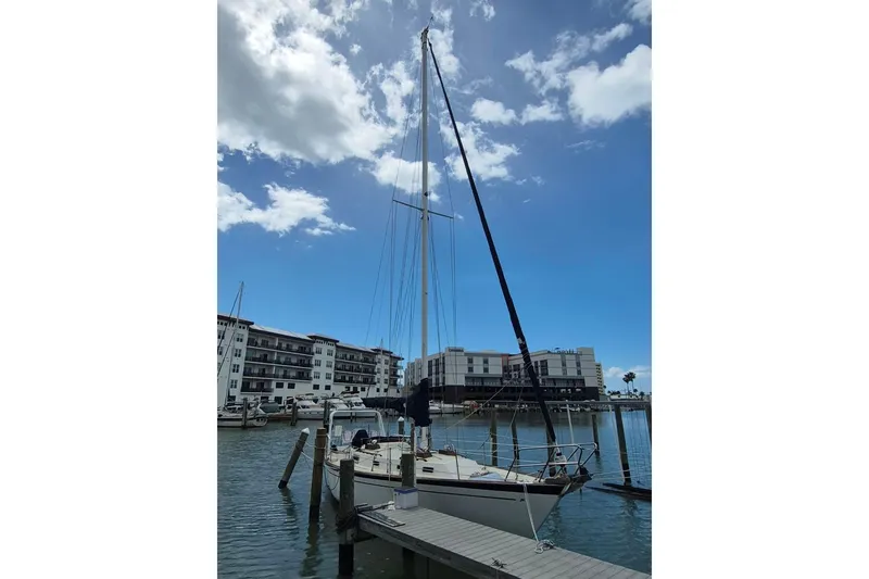 Slide: The Image of 1987 Morgan 384 sailboat docked at marina under blue sky. - 2