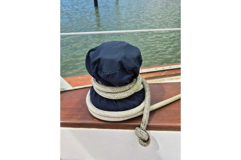 Slide: The Image of Sailboat winch with rope on 1987 Morgan 384, docked by the water. - 22