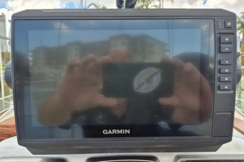 Slide: The Image of Garmin marine GPS device on a 1987 Morgan 384 sailboat, reflecting surroundings. - 26