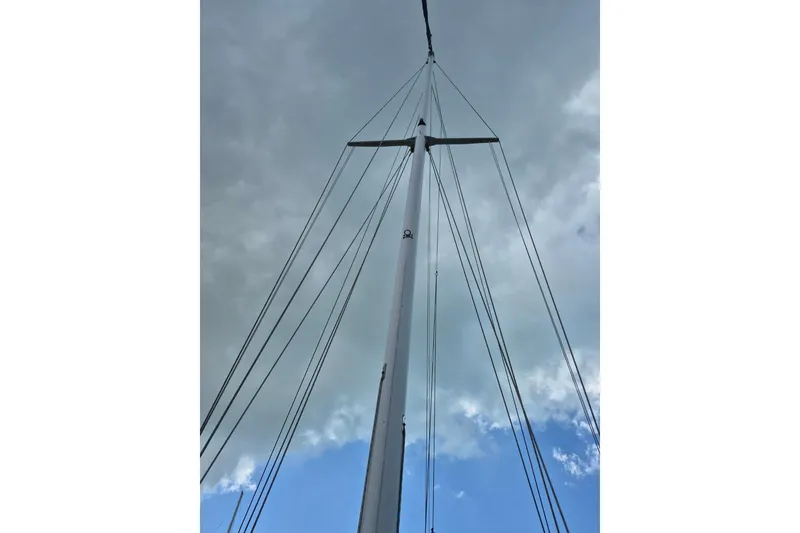 Slide: The Image of Tall mast of 1987 Morgan 384 sailboat against cloudy sky. - 3
