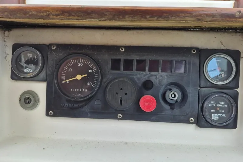 Slide: The Image of 1987 Morgan 384 boat dashboard with gauges and controls, including tachometer and fuel indicators. - 30