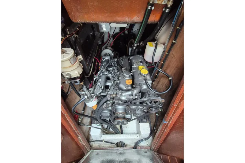 Slide: The Image of Engine compartment of a 1987 Morgan 384 sailboat, showcasing detailed mechanical components. - 32